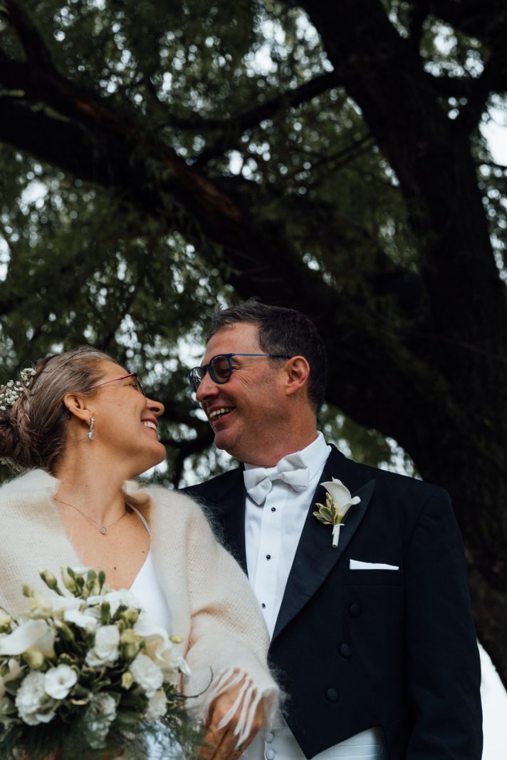 a man and woman smiling and looking at each other